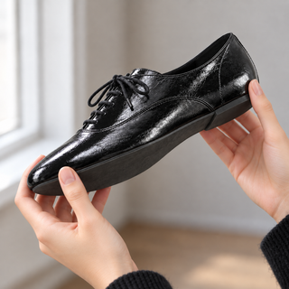 how to stop shoes from squeaking - examining the sole of a leather shoe