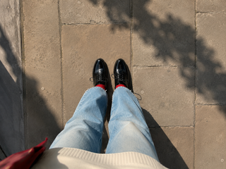 A young woman looking down at her shoes