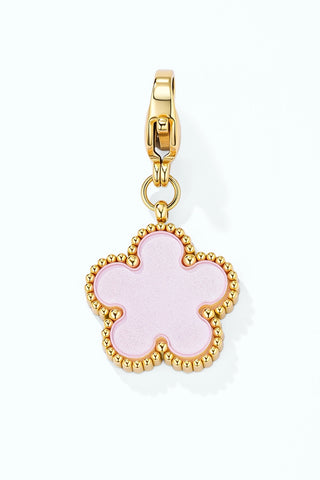 Gold-tone flower charm with a pale pink enamel centre and a beaded edge, on a clip clasp