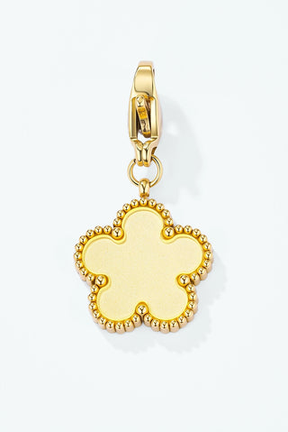 Gold-tone flower charm with a pale yellow enamel centre and a beaded edge, on a clip clasp
